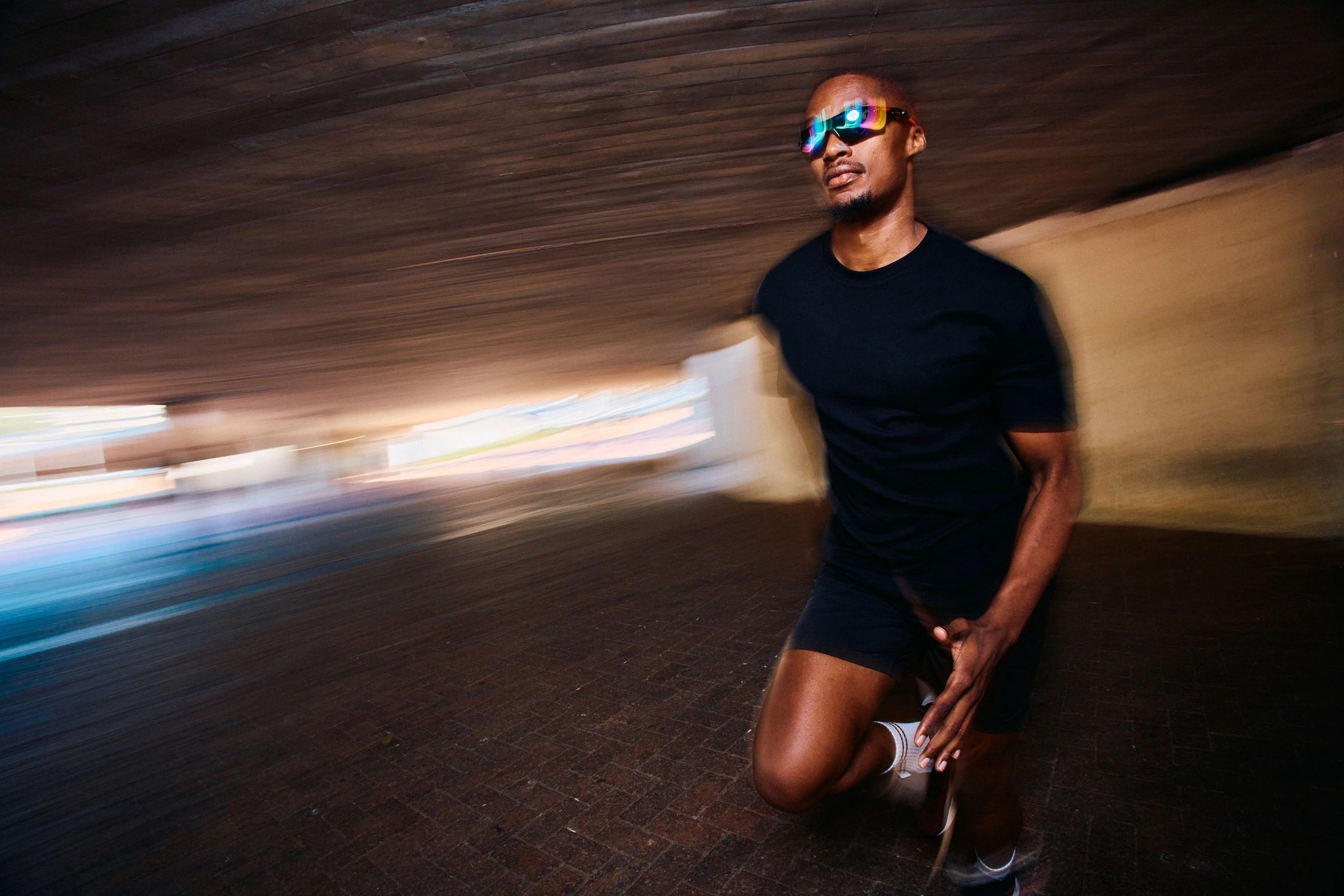 Runner training in an urban tunnel, representing athletic recovery and performance